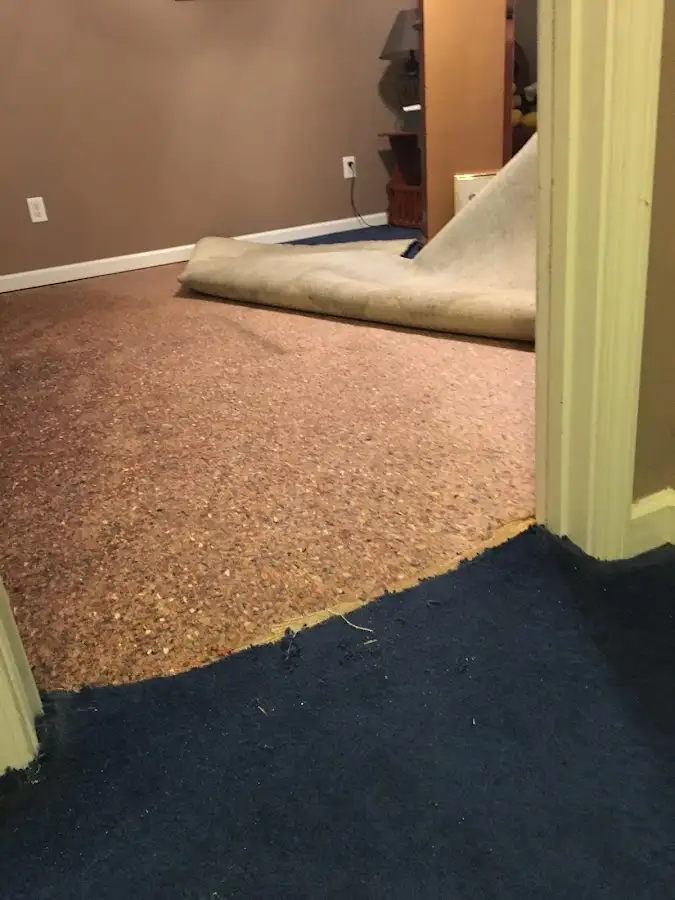 Carpet pad removal revealing water damage during Drying & Dehumidification in Council Bluffs